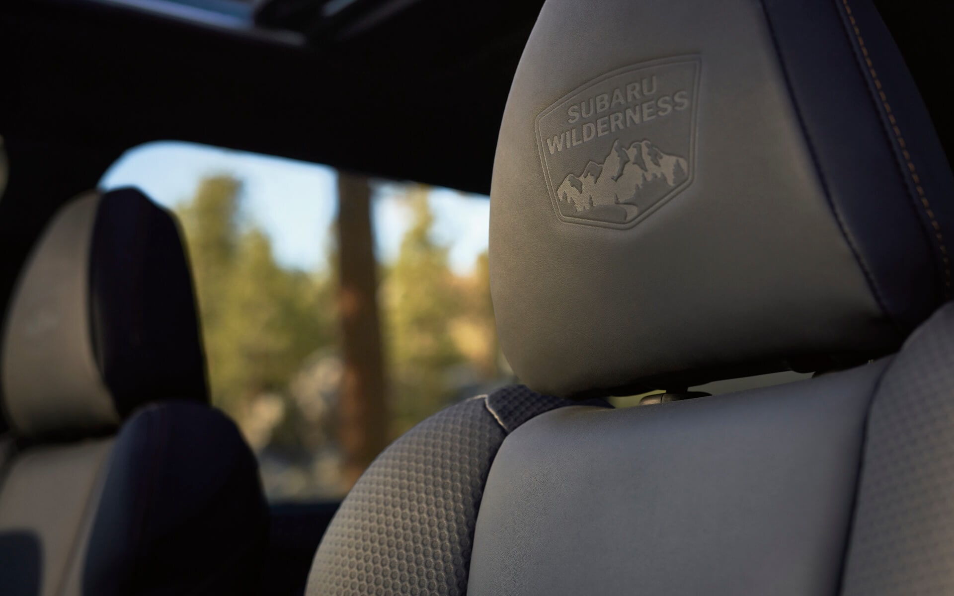 A close up of the StarTex® upholstery with the Wilderness badge embroidered on the front seat.